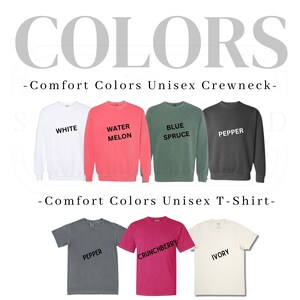 May include: A display of Comfort Colors unisex crewnecks and t-shirts in various colors, including white, water melon, blue spruce, pepper, crunchberry, and ivory.