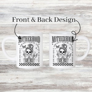 May include: White ceramic mug with a black and white illustration of a skeleton with a butterfly on its shoulder. The text "Motherhood. Some days I rock it. Some days it rocks me. Either way we are rockin'" is printed on the mug.