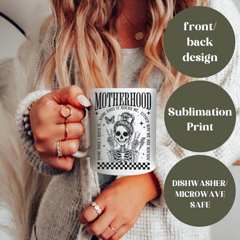 May include: White ceramic mug with a black and white illustration of a skeleton with a bow in its hair. The text "Motherhood Some Days I Rock It. Some Days It Rocks Me. Either Way We Are Rockin'" is printed on the mug.
