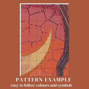 May include: A cross-stitch pattern with a colorful design of a tree with orange, red, and yellow leaves. The pattern is easy to follow with color symbols.
