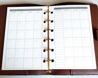 May include: A brown leather binder with a gold six-ring mechanism holding white planner pages. The left page shows a weekly calendar grid for Thursday through Sunday. The right page features a monthly tracker and a weekly schedule.