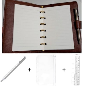 May include: A brown leather-textured six-ring binder with lined white paper, a silver pen, a clear plastic zipper pouch, and a clear plastic ruler with markings up to 12 centimeters. The binder features gold-toned rings and a pen loop.