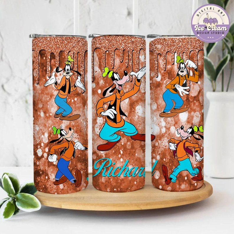 May include: Three stainless steel tumblers with a brown glitter background and a cartoon image of Goofy. The tumblers have the name "Richard" on the middle tumbler.