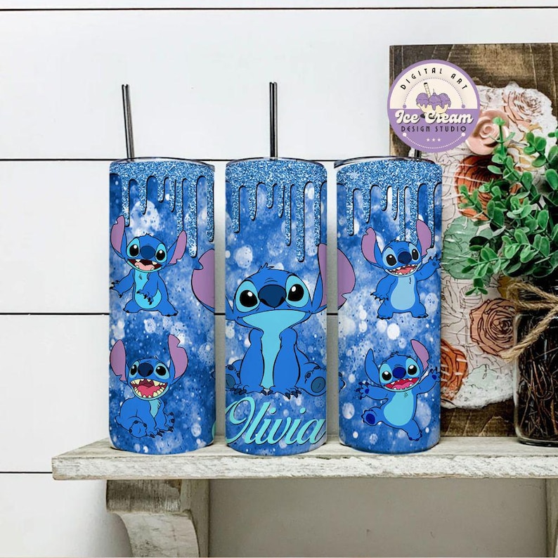 May include: Three stainless steel tumblers with a blue glitter background and a cartoon Stitch character design. The middle tumbler has the name "Olivia" written on it.