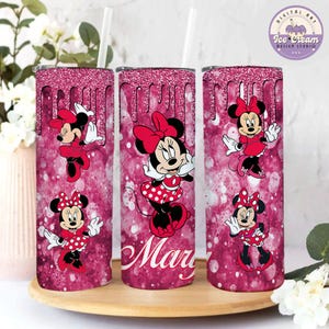 May include: Three pink glitter tumblers with a dripping effect. Each tumbler features a different image of Minnie Mouse in a red dress with white polka dots. The middle tumbler has the name "Mary" written in white.