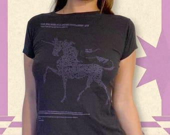 May include: Dark gray t-shirt featuring a unicorn graphic composed of text. The text is in a lighter gray color. The shirt has short sleeves and a crew neck. The text "OUDE SPACE FICTION" is printed at the top of the shirt.
