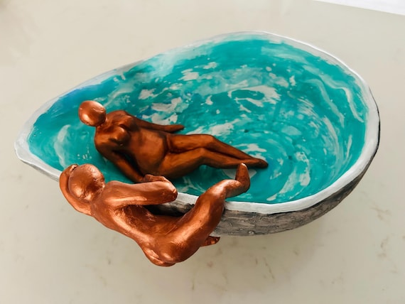 A $6,000 ceramic bowl populated with handmade bronze human figures — ambitious figurative fine art that blurs the line between sculpture and vessel.