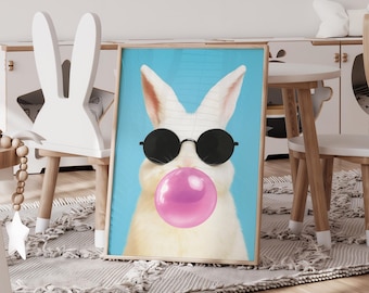 May include: A framed print featuring a white rabbit wearing black sunglasses and blowing a large pink bubble. The rabbit is set against a light blue background. The artwork has a playful and whimsical theme, suitable for a child's room.