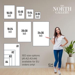 a woman standing in front of a gallery wall, with various sizes of framed artworks displayed on the wall. The gallery offers ISO size options (A1-A3-A4) for EU orders only, ranging from 6" to 17" in height.