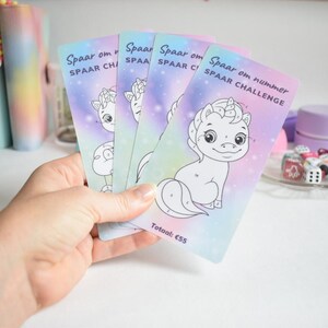 May include: Four colorful cards with a unicorn design and the text "Spaar om nummer Spaar Challenge" and "Totaal: €55".