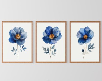 May include: A set of three framed wall art prints, each featuring a single watercolor-style blue flower with a yellow center and green leaves on a white background, enclosed in a simple light brown wooden frame.