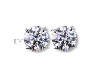 May include: A pair of silver stud earrings with clear round cubic zirconia stones.