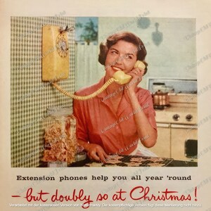 May include: A woman in a red dress uses a yellow wall-mounted phone. The phone has a cord that connects to the receiver. The text on the ad reads "Extension phones help you all year 'round - but doubly so at Christmas!"