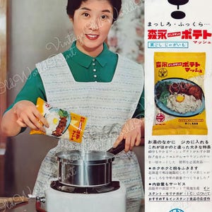 May include: A woman in a green shirt and white apron is preparing a meal using a package of instant mashed potatoes. The package is yellow with a picture of a bowl of mashed potatoes with a fried egg on top. The text on the package reads "森永ポテト マッシュ" in Japanese. The text "新発売" which means "New Release" is also visible in the image.