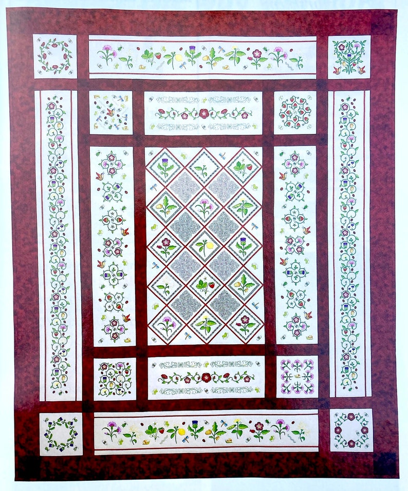 An embroidered quilt displayed square on. The quilt has a cream background and maroon borders, with fine maroon and green patterning. The central pattern is a diagonal grid design and there are floral motifs around the borders.