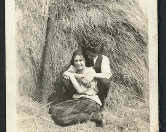 Affectionate Smiling Lovebirds Couple Hug Cuddle Embrace on Hay Bale Man Woman Vintage Photo Snapshot 1930s Fashion Romance Love