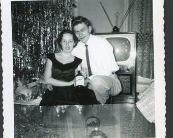 Affectionate Couple Pose with Liquor Bottle by the Christmas Tree Vintage Square Photo Snapshot 1950s Interior Decorations Tinsel TV