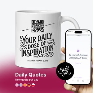 May include: White ceramic mug with the text "Your Daily Dose of Inspiration" in black script. A QR code is above the text. A smartphone displays a quote: "Be yourself. Everyone else is already taken."