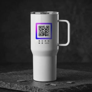 May include: A white stainless steel travel tumbler with a handle and a clear lid. The front features a square QR code with a purple to blue gradient border, accompanied by the black text "SCAN ME" and a small website URL printed below it.