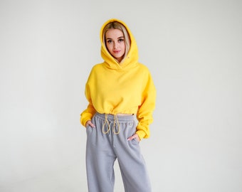 Warm knitted suit- wide,long trousers with a high waist,side pockets,laces at the waist and short oversize hoodie with adjustable rubber