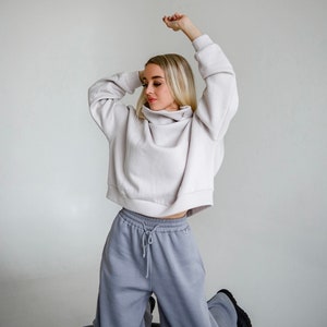 A warm knitted suit wide,long trousers with a high waist,side pockets, rubber,laces at the waist and an oversize sweater with a high collar image 5