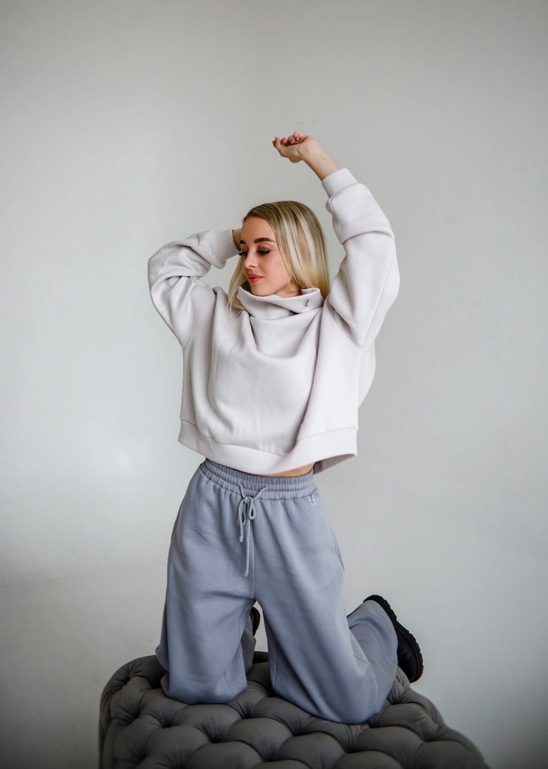 A warm knitted suit wide,long trousers with a high waist,side pockets, rubber,laces at the waist and an oversize sweater with a high collar image 5