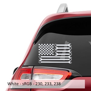 May include: White vinyl decal of an American flag with wrenches instead of stripes. The flag is on the back window of a red car.