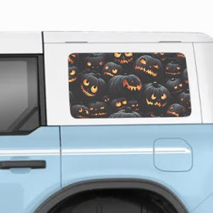 May include: A blue car with a rear window decal of a pattern of black and orange jack-o'-lantern pumpkins.