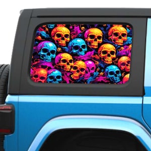 May include: A colorful car window decal featuring a repeating pattern of skulls in shades of pink, blue, and yellow.