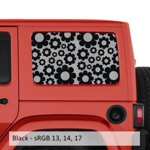 May include: A rectangular window decal applied to the side of a bright red vehicle. The decal features a repeating pattern of solid black flowers with light gray centers, covering the entire surface of the rear side window of the car.