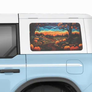 May include: A colorful fall-themed car window cling featuring a vibrant landscape with pumpkins, trees, and a sunset. The artwork is displayed on a light blue vehicle, creating a seasonal decorative accent.