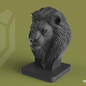 May include: A dark grey lion head sculpture on a square base. The lion's mane and facial features are intricately detailed. The sculpture is set against a muted green background with a logo in the bottom right corner.