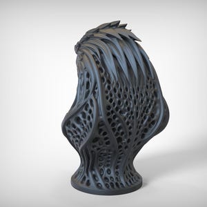 May include: A dark gray, abstract sculpture with a complex, organic design. The piece features a textured surface with numerous holes and a spiky top, resembling a stylized plant or creature. The base is round and stable.