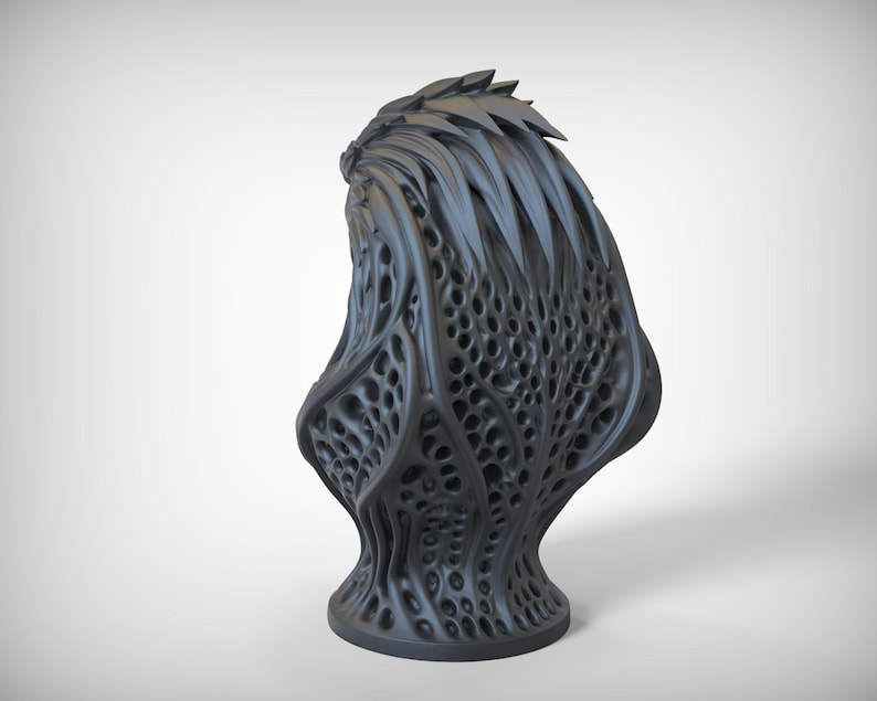 May include: A dark gray, abstract sculpture with a complex, organic design. The piece features a textured surface with numerous holes and a spiky top, resembling a stylized plant or creature. The base is round and stable.