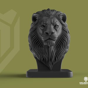 May include: A black lion head sculpture with detailed mane and facial features, mounted on a rectangular base. The background is a muted olive green with a geometric design on the left. The logo "MUSDAN INDUSTRIAL DESIGN" is in the bottom right corner.