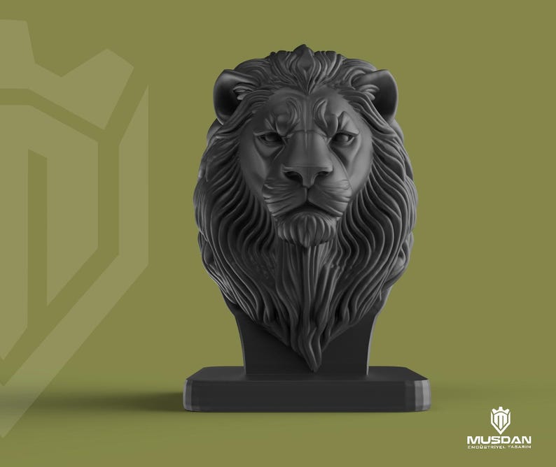 May include: A black lion head sculpture with detailed mane and facial features, mounted on a rectangular base. The background is a muted olive green with a geometric design on the left. The logo "MUSDAN INDUSTRIAL DESIGN" is in the bottom right corner.