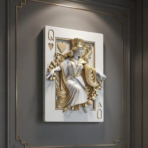 May include: A white and gold Queen of Hearts playing card wall art. The card features a detailed relief sculpture of a queen wearing a crown and flowing robes. The card is mounted on a gray wall with gold trim.