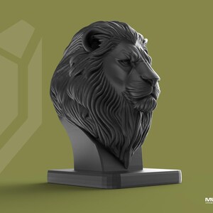 May include: A black lion head sculpture with a detailed mane and facial features. The sculpture is mounted on a rectangular base. The background is a muted olive green. The sculpture is a decorative item.