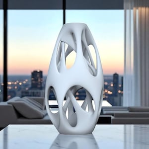May include: A white, abstract decorative vase with an open, cage-like design. The vase has a smooth, matte finish and is placed on a marble-like surface. The background features a cityscape and a modern interior.