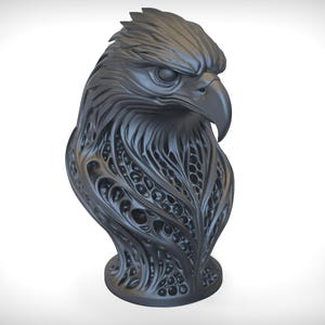 May include: A dark gray sculpture of an eagle's head and upper body. The eagle's feathers and body are intricately detailed with a flowing, organic pattern. The sculpture has a smooth, matte finish and sits on a round base.