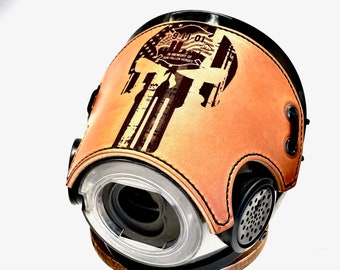 May include: A tan leather motorcycle helmet with a black skull graphic and the text "9-11-01 In Memory of Our Fallen Heroes".
