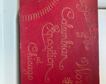 May include: A vintage red card with gold lettering and a gold ribbon. The card reads "Photo-Glimpses of the Worlds Columbian Exposition at Chicago."