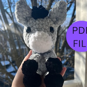 May include: A crochet pattern for a gray donkey with black hooves and a black mane. The pattern is available as a PDF download.