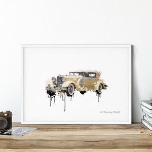May include: A framed print of a vintage car, rendered in a watercolor style. The car is a cream color with black accents, and the image has a dripping paint effect. The text "1929 Duesenberg Model J" is visible in the lower right corner.