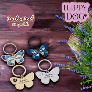 Personalized engraved dog ID tag in the shape of a colorful butterfly. Dog tag, medallion, or identification label.