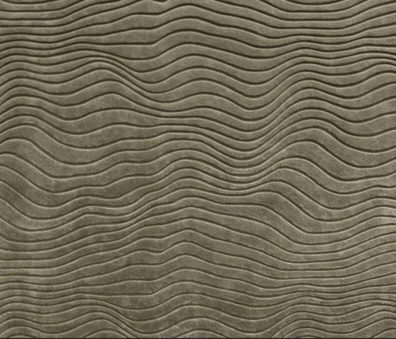 May include: A close-up of a textured, wavy, brown surface. The surface has a subtle, embossed pattern of curved lines.