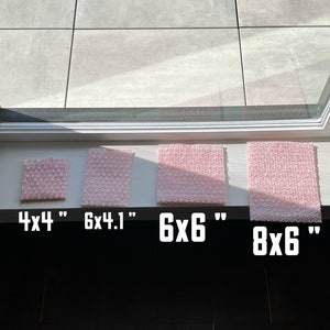 May include: Four pink foam squares of different sizes. The squares are labeled with their dimensions: 4x4", 6x4.1", 6x6", and 8x6".