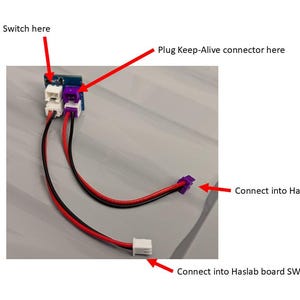 May include: A blue circuit board with three wires connected to it. The wires are labeled "Connect Pack Main Switch here", "Plug Keep-Alive connector here", "Connect into Haslab board U7 connector", and "Connect into Haslab board SW1 connector".