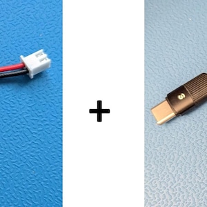 Könnte beinhalten: Ein rotes und schwarzes Kabel mit einem weißen Stecker an jedem Ende, eine kleine grüne Platine mit einem USB-C-Stecker und ein schwarzes geflochtenes USB-C-Kabel.