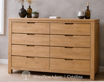 May include: A light brown wooden dresser featuring eight drawers arranged in two vertical columns. Each drawer has a horizontal cutout handle. The text WoodYouAdore | Catalina is printed at the bottom center of the image with a tree icon.